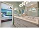 Bathroom with double vanity and an open view to the primary bedroom at 3103 77Th E Dr, Sarasota, FL 34243