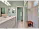Modern bathroom featuring a double vanity, walk-in shower, and tiled floors at 3103 77Th E Dr, Sarasota, FL 34243