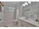 Bright, clean bathroom featuring white tile, vanity, and shower/tub combo at 3103 77Th E Dr, Sarasota, FL 34243