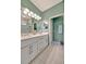 Clean bathroom featuring a double vanity, walk-in shower, and tiled floors at 3103 77Th E Dr, Sarasota, FL 34243