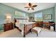 Primary bedroom with a ceiling fan, ensuite bathroom, and view to the outside at 3103 77Th E Dr, Sarasota, FL 34243