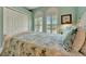 Beautiful bedroom with light blue walls, shuttered windows, and a closet at 3103 77Th E Dr, Sarasota, FL 34243