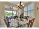 Cozy breakfast nook with a glass-top table, seating for four, and serene outdoor views at 3103 77Th E Dr, Sarasota, FL 34243