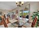 Breakfast nook with a glass table and view to the outside patio and backyard at 3103 77Th E Dr, Sarasota, FL 34243