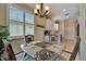 Charming breakfast nook with a glass-top table, plantation shutters, and decorative accents at 3103 77Th E Dr, Sarasota, FL 34243