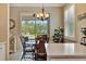 Breakfast nook with a decorative chandelier and bright light due to the backyard sliding doors at 3103 77Th E Dr, Sarasota, FL 34243
