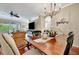 Dining area featuring a chandelier, wood floors, and decorative wall art at 3103 77Th E Dr, Sarasota, FL 34243