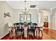 Bright dining space with wood floors, decorative wall art, and an elegant chandelier at 3103 77Th E Dr, Sarasota, FL 34243