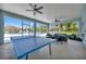 A game room with ping pong and a table for six overlooks the community pool at 3103 77Th E Dr, Sarasota, FL 34243