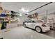 Spacious garage with storage and parked white convertible car at 3103 77Th E Dr, Sarasota, FL 34243