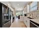 Bright and airy kitchen with white cabinets, stainless steel appliances, and an open layout at 3103 77Th E Dr, Sarasota, FL 34243