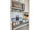 Stainless steel microwave and oven with white cabinets and decorative backsplash at 3103 77Th E Dr, Sarasota, FL 34243