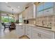 Bright kitchen featuring white cabinets, stainless steel sink, and outdoor views to the backyard at 3103 77Th E Dr, Sarasota, FL 34243