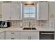 Modern kitchen with white cabinetry, stainless steel appliances, and a clean, contemporary design at 3103 77Th E Dr, Sarasota, FL 34243