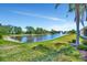 Waterfront view of the lake with a fountain and surrounding trees at 3103 77Th E Dr, Sarasota, FL 34243
