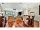 Open-concept living room and dining area featuring hardwood floors and backyard views at 3103 77Th E Dr, Sarasota, FL 34243