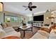 Inviting living room with wood floors, neutral décor, and sliding glass doors to the backyard at 3103 77Th E Dr, Sarasota, FL 34243