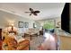 Comfortable living room featuring hardwood floors, stylish furnishings, and backyard access at 3103 77Th E Dr, Sarasota, FL 34243