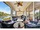 Covered patio with seating and access to the pool and beautiful waterfront view at 3103 77Th E Dr, Sarasota, FL 34243