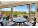 Screened patio seating area featuring views of the lake at 3103 77Th E Dr, Sarasota, FL 34243