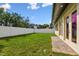 Large backyard featuring a well-maintained lawn, privacy fence, and access from the house at 3111 W Nassau St, Tampa, FL 33607