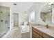 Bright bathroom with a glass shower, soaking tub, double sink vanity, and modern finishes at 3111 W Nassau St, Tampa, FL 33607