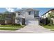 Charming two-story home with a welcoming facade, two-car garage, and a well-manicured lawn at 3111 W Nassau St, Tampa, FL 33607