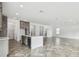 Open-concept kitchen featuring a large island, stainless steel appliances, and herringbone-patterned floors at 3111 W Nassau St, Tampa, FL 33607