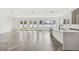 Bright, open-concept living room featuring expansive windows, hard surface floors, and modern finishes at 3111 W Nassau St, Tampa, FL 33607