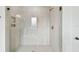 Bright and airy glass enclosed shower with a modern design featuring a rain shower head at 3111 W Nassau St, Tampa, FL 33607