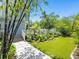 Backyard featuring lush greenery, a walkway, and a lawn, blending nature and modern living at 324 Julia Pl, Sarasota, FL 34236