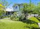 Backyard featuring manicured lawn, a garden, a deck with seating and greenery, creating a private oasis at 324 Julia Pl, Sarasota, FL 34236