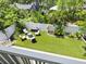 Aerial view of a backyard with manicured lawn, lush landscaping, and cozy fire pit area at 324 Julia Pl, Sarasota, FL 34236
