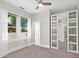 Bright bedroom featuring a ceiling fan, closet with mirrored doors, and sunlit windows at 324 Julia Pl, Sarasota, FL 34236
