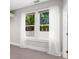 Bedroom with large windows providing natural light and pleasant views of tropical trees at 324 Julia Pl, Sarasota, FL 34236