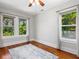 Bright and airy bedroom with hardwood floors and bright sunlight coming in through the windows at 324 Julia Pl, Sarasota, FL 34236