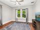 Comfortable bedroom with hardwood floors, soft rug and view of tropical palm trees at 324 Julia Pl, Sarasota, FL 34236