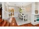 Bright dining room adjacent to the living room and kitchen, featuring hardwood floors and a stylish chandelier at 324 Julia Pl, Sarasota, FL 34236
