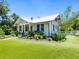 Charming home with a manicured lawn and lush landscaping, enhancing its curb appeal and natural beauty at 324 Julia Pl, Sarasota, FL 34236