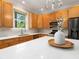 Modern kitchen with white countertops, wooden cabinets, and stainless steel appliances at 324 Julia Pl, Sarasota, FL 34236