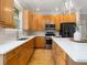 Bright kitchen featuring wooden cabinets, stainless steel appliances, and a center island at 324 Julia Pl, Sarasota, FL 34236