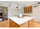 Open kitchen with white countertops, wood cabinets, and eat-in island with pendant lighting at 324 Julia Pl, Sarasota, FL 34236
