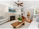 Spacious living room with fireplace, hardwood floors, and open access to the dining area at 324 Julia Pl, Sarasota, FL 34236