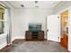 Relaxing living room with a TV on a rustic media console, and a doorway at 324 Julia Pl, Sarasota, FL 34236