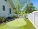 Backyard featuring a putting green with lush landscaping, creating a private recreational space at 324 Julia Pl, Sarasota, FL 34236
