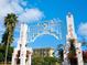 A beautiful Sarasota Bayfront sign framed by palm trees, flowers, and blue skies create a welcoming entrance at 324 Julia Pl, Sarasota, FL 34236