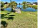 Picturesque backyard view of a private dock overlooking a tranquil pond at 3325 Honeymoon Ln, Holiday, FL 34691
