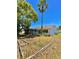 Spacious backyard featuring mature trees and a screened-in porch, perfect for outdoor relaxation at 3325 Honeymoon Ln, Holiday, FL 34691