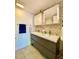 Modern bathroom with double sink vanity, updated fixtures, and decorative backsplash at 3325 Honeymoon Ln, Holiday, FL 34691