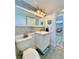 Bathroom featuring a vanity, a toilet, and a decorative mirror at 3325 Honeymoon Ln, Holiday, FL 34691